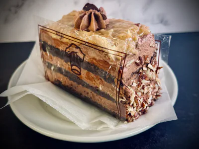 Rich chocolate layer cake slice with cream filling